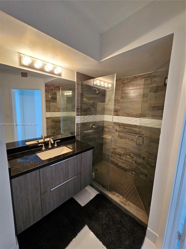bathroom with vanity and a stall shower