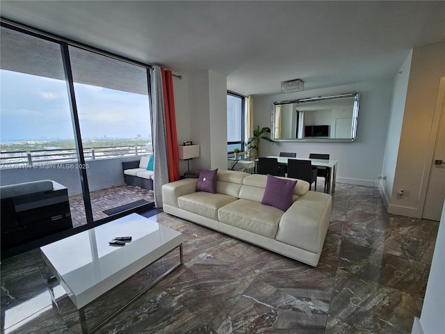living area with baseboards and marble finish floor