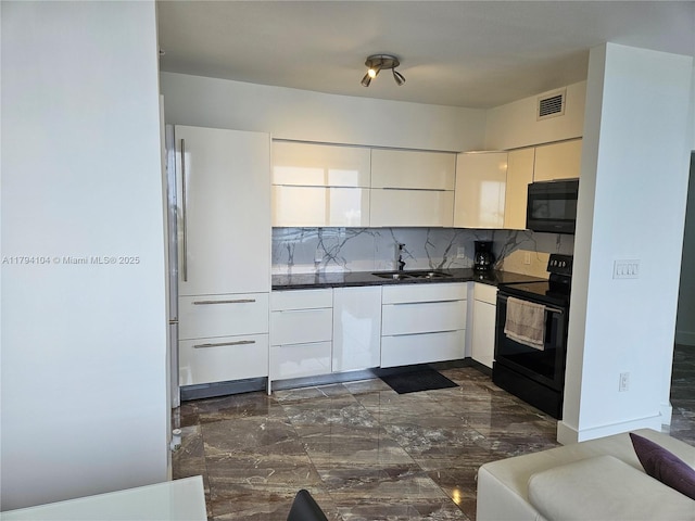 kitchen with dark countertops, a sink, marble finish floor, visible vents, and black appliances
