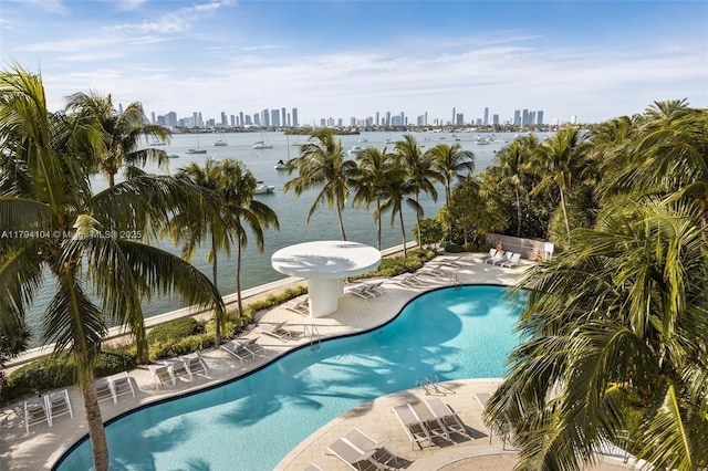 pool featuring a view of city, a water view, and a patio area