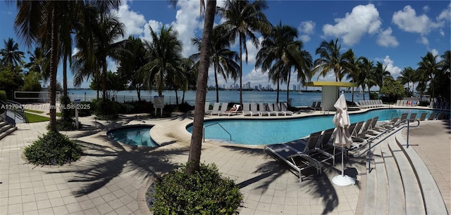 community pool featuring fence and a patio