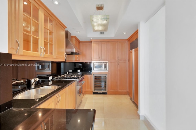 17875 Collins Ave Unit 905, Sunny Isles Beach, FL 33160 - kitchen featuring wall chimney range hood, dark countertops, a sink, beverage cooler, and stainless steel appliances