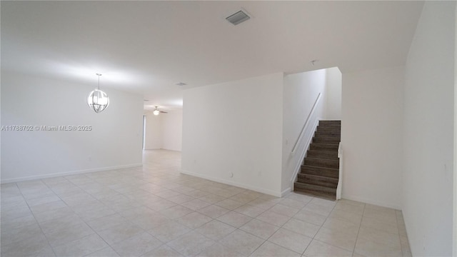 unfurnished room with light tile patterned floors, ceiling fan with notable chandelier, stairs, and visible vents