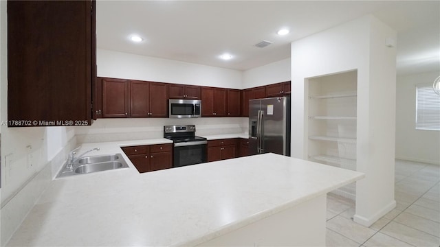 kitchen with visible vents, light tile patterned flooring, light countertops, a sink, and stainless steel appliances