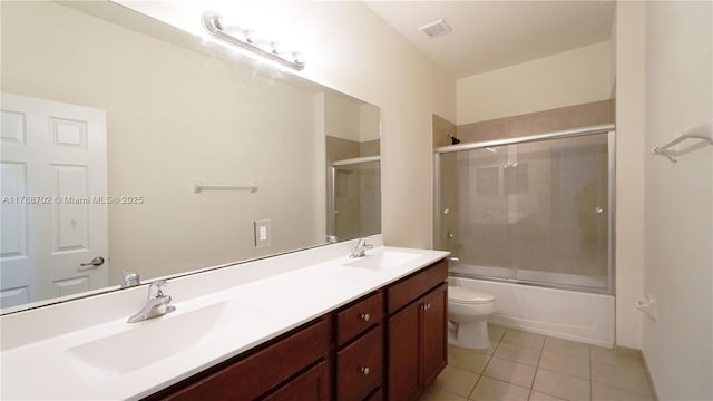bathroom with tile patterned flooring, a sink, double vanity, and visible vents