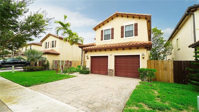 mediterranean / spanish-style house with a garage, stucco siding, decorative driveway, and a tile roof