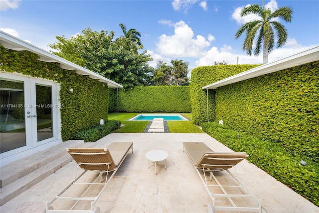 view of patio featuring a fenced in pool and french doors