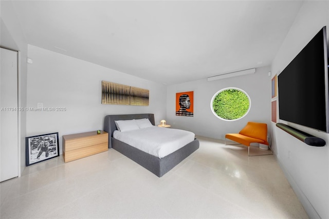 bedroom with baseboards and speckled floor