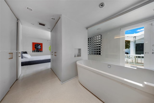 ensuite bathroom with visible vents, a freestanding bath, and ensuite bath