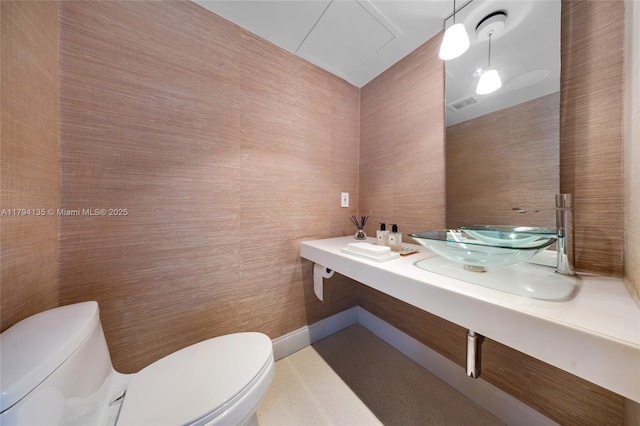 bathroom featuring visible vents, a sink, and toilet
