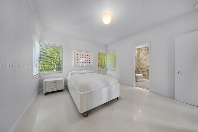 bedroom featuring crown molding, baseboards, and ensuite bathroom