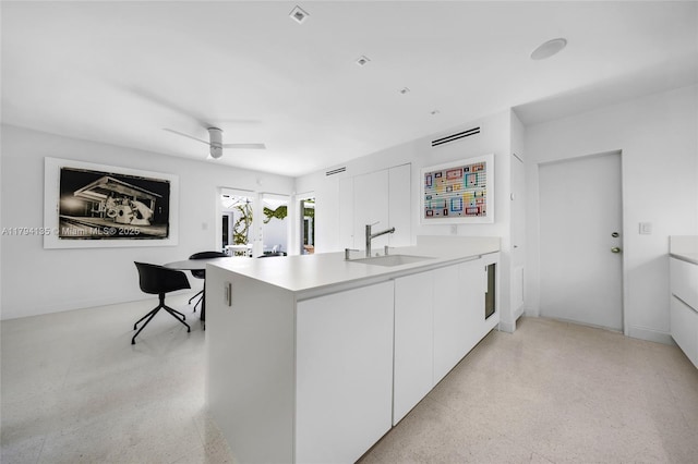 kitchen featuring a sink, modern cabinets, white cabinetry, and ceiling fan