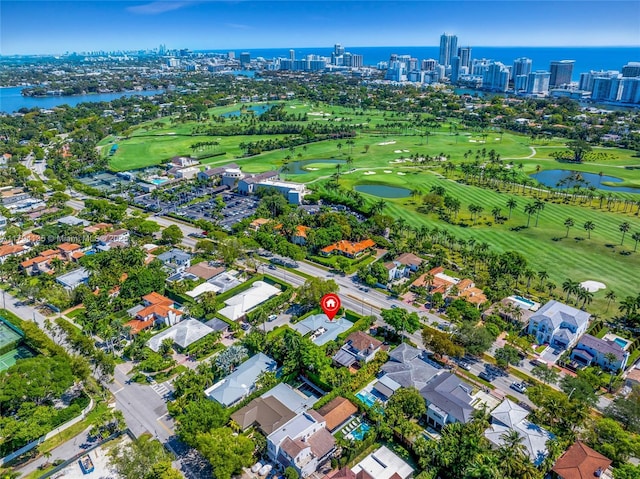 birds eye view of property with a city view, a water view, and golf course view