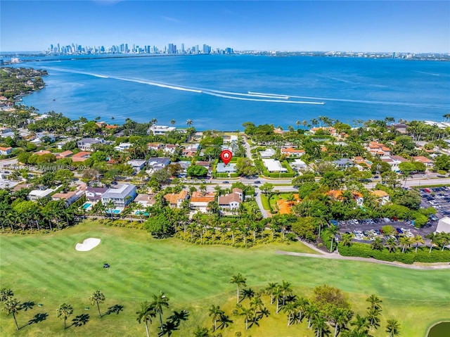 drone / aerial view with a water view, a residential view, a city view, and golf course view