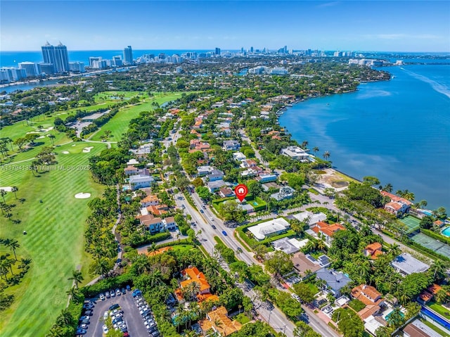 birds eye view of property featuring a view of city, view of golf course, and a water view