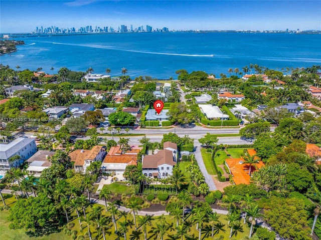 drone / aerial view featuring a view of city and a water view