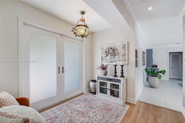 entryway featuring crown molding, french doors, recessed lighting, baseboards, and wood finished floors