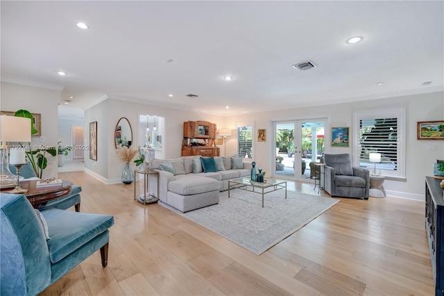 living room with a wealth of natural light, ornamental molding, recessed lighting, and visible vents