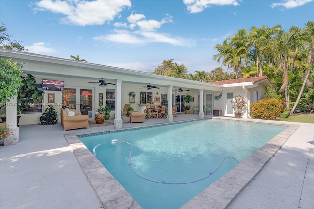pool featuring a patio, a ceiling fan, and an outdoor living space