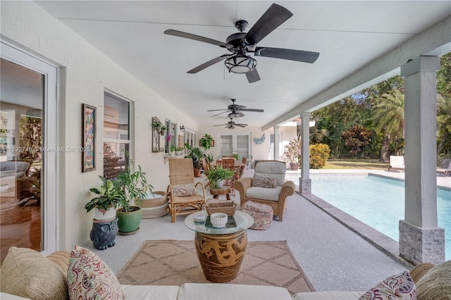 view of patio / terrace featuring a ceiling fan and an outdoor pool