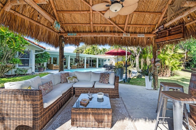 view of patio / terrace featuring a gazebo, a ceiling fan, and an outdoor hangout area