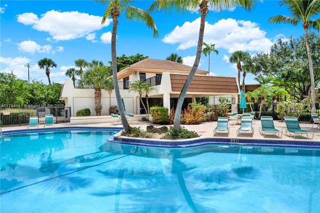 pool featuring a patio and fence
