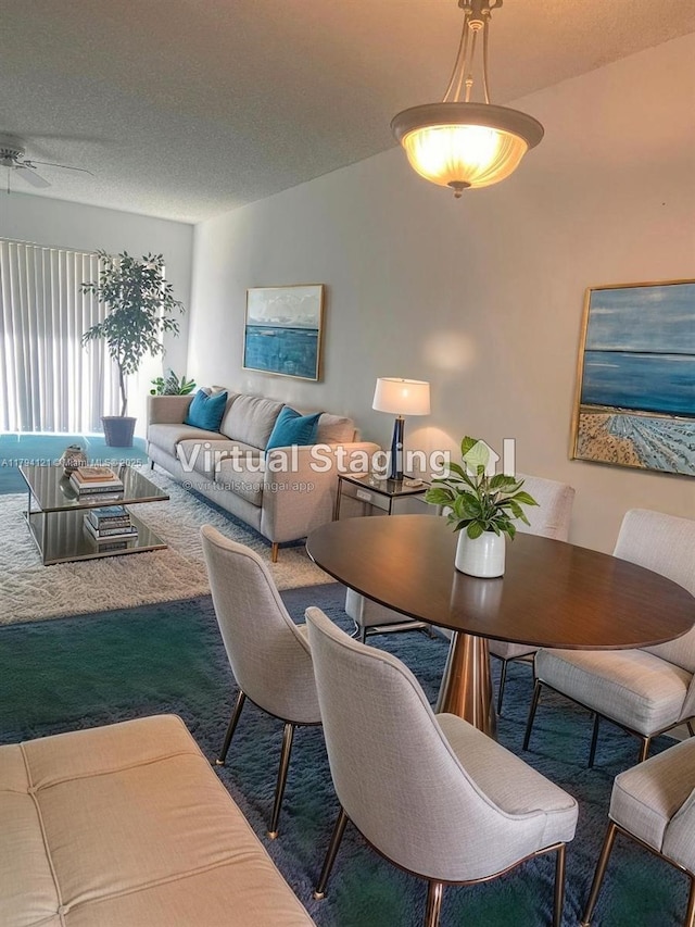 dining area with carpet flooring and a textured ceiling