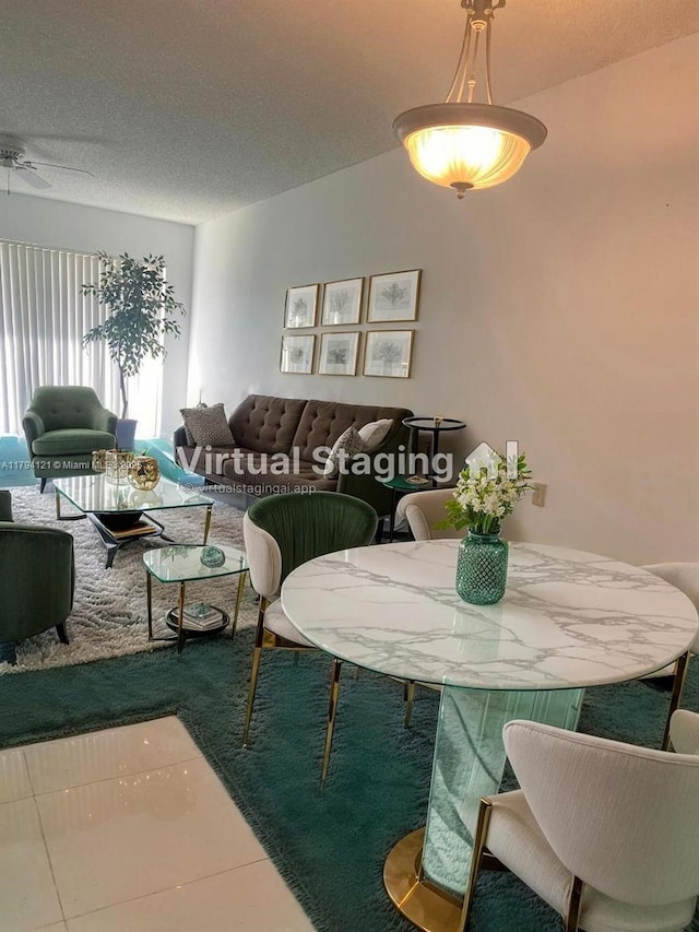 dining room featuring a textured ceiling and tile patterned floors