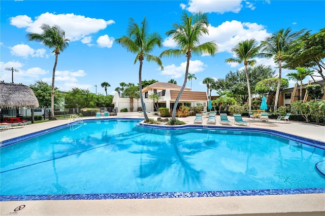 pool featuring fence and a patio