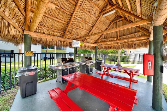 view of patio with area for grilling, a gazebo, and fence