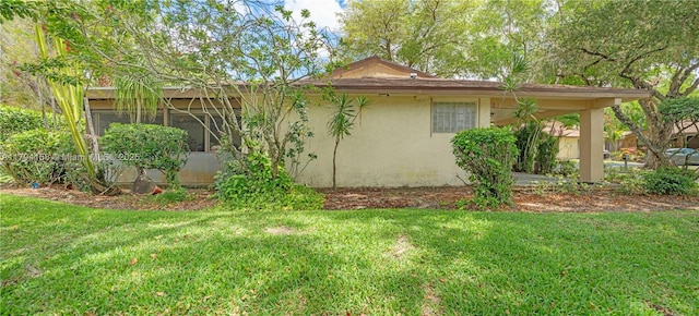 8097 Royal Palm Cir, Tamarac, FL 33321 - view of property exterior with a sunroom, stucco siding, and a yard