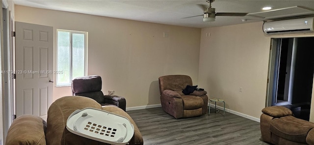3100-3112 Sanders Rd, Davenport, FL 33837 - sitting room with baseboards, a wall unit AC, a healthy amount of sunlight, and wood finished floors