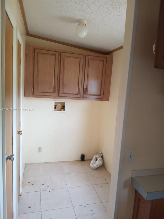 3100-3112 Sanders Rd, Davenport, FL 33837 - laundry area featuring cabinet space, a textured ceiling, washer hookup, and tile patterned flooring