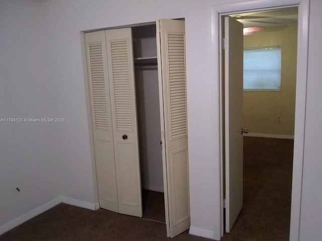 3100-3112 Sanders Rd, Davenport, FL 33837 - unfurnished bedroom featuring baseboards, a closet, and dark colored carpet