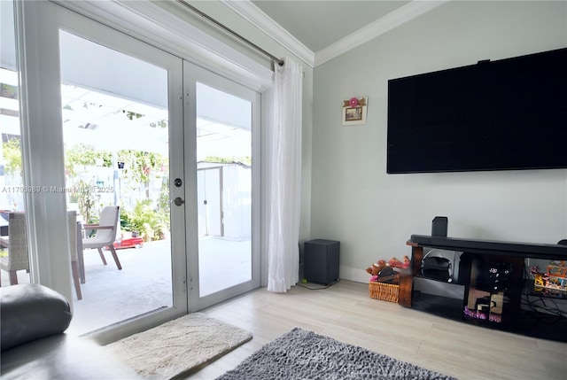 doorway to outside featuring crown molding, french doors, and wood finished floors