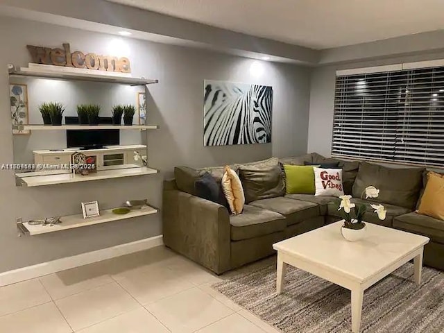 310 Golden Isles Dr Unit 109, Hallandale Beach, FL 33009 - living area featuring tile patterned floors and baseboards