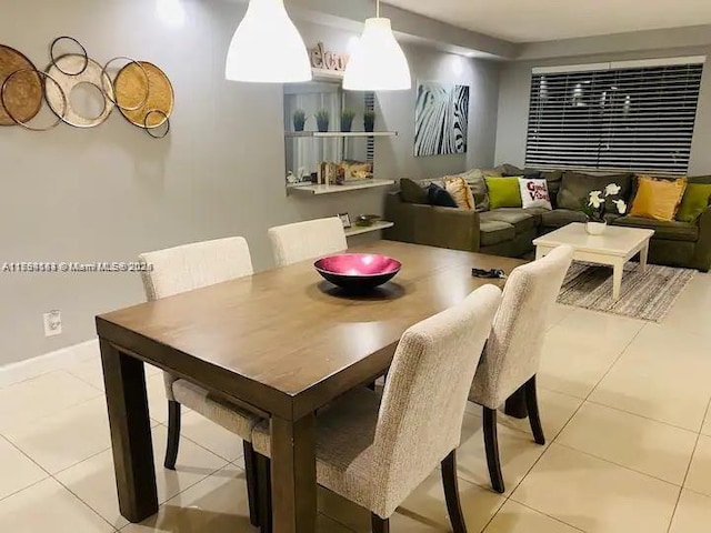 310 Golden Isles Dr Unit 109, Hallandale Beach, FL 33009 - dining room featuring baseboards and light tile patterned flooring