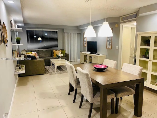 310 Golden Isles Dr Unit 109, Hallandale Beach, FL 33009 - dining area featuring baseboards, visible vents, and light tile patterned floors