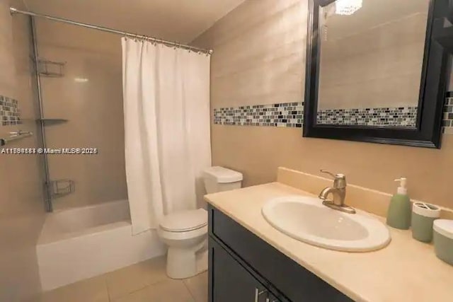 310 Golden Isles Dr Unit 109, Hallandale Beach, FL 33009 - full bath featuring tile patterned flooring, vanity, toilet, shower / bathtub combination with curtain, and tile walls