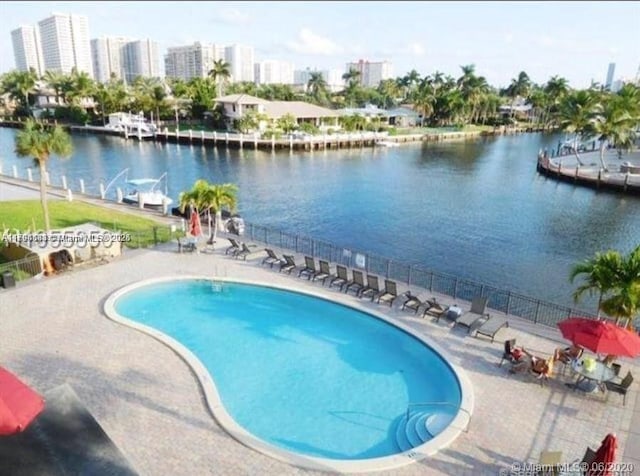 310 Golden Isles Dr Unit 109, Hallandale Beach, FL 33009 - pool with a water view, fence, and a patio area