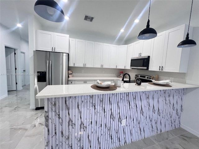920 E Barton St, Lehigh Acres, FL 33974 - kitchen featuring stainless steel appliances, baseboards, light marble finish flooring, and a peninsula