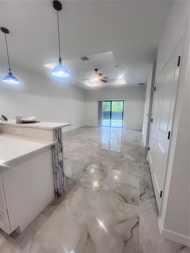920 E Barton St, Lehigh Acres, FL 33974 - empty room with light marble finish floors and a ceiling fan