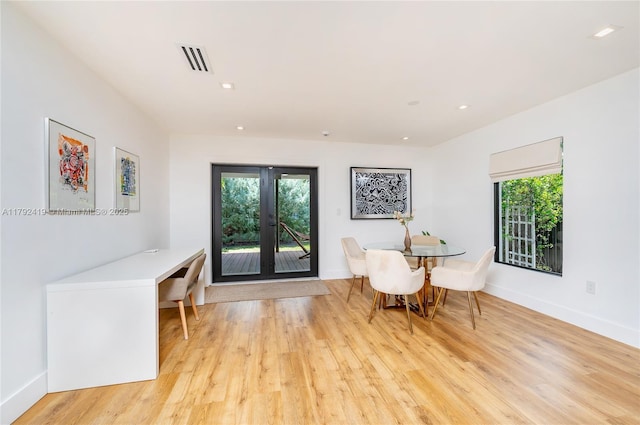dining area featuring light wood-style floors, a wealth of natural light, french doors, and visible vents