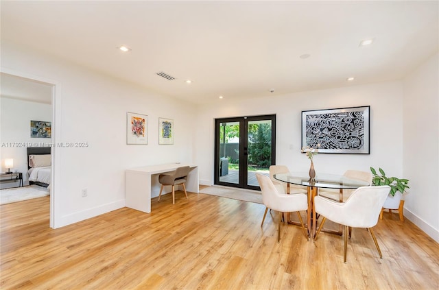 dining room with light wood-style floors, baseboards, and visible vents