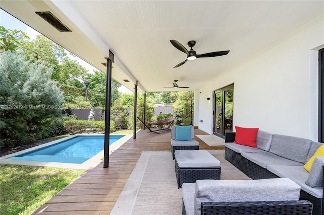 exterior space with a fenced backyard, a ceiling fan, a wooden deck, and an outdoor living space