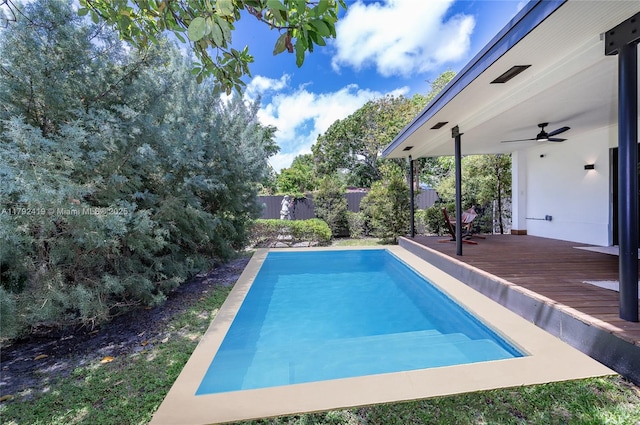 view of pool featuring a fenced backyard, a ceiling fan, and a wooden deck