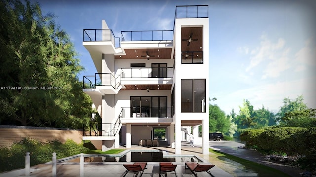 back of property with stairs, stucco siding, a balcony, a ceiling fan, and a patio