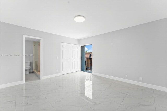2557 Lakeview Ct Unit 2557, Cooper City, FL 33026 - unfurnished bedroom with light marble finish floors, baseboards, ensuite bathroom, and a closet