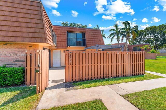 2557 Lakeview Ct Unit 2557, Cooper City, FL 33026 - view of front of home featuring a gate, mansard roof, and brick siding