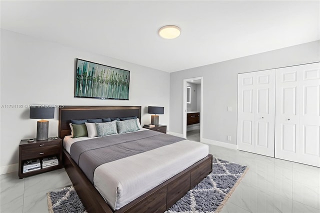 2557 Lakeview Ct Unit 2557, Cooper City, FL 33026 - bedroom featuring marble look tile flooring, baseboards, connected bathroom, and a closet